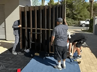 SD Moving Services team preparing large custom furniture for secure storage