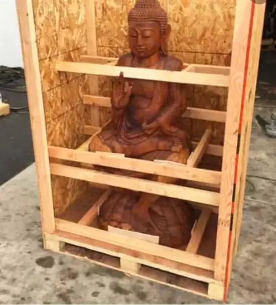 Wooden Buddha statue securely framed inside a custom wooden crate for fine art moving services in Palm Desert.